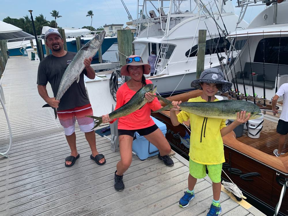 Family with mahi and kingfish at a Stuart dock